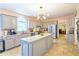Open kitchen with gray cabinets, granite countertops, stainless steel appliances, and tile floor at 3740 Ashford Ne Pt, Brookhaven, GA 30319