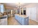 Spacious kitchen with granite island, stainless appliances, tile flooring, and a modern light fixture at 3740 Ashford Ne Pt, Brookhaven, GA 30319
