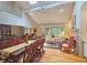An open-concept living and dining area with hardwood floors, vaulted ceilings, and a fireplace at 3740 Ashford Ne Pt, Brookhaven, GA 30319