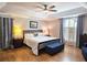 Inviting primary bedroom with tray ceiling, hardwood floors, and ensuite bathroom at 3740 Ashford Ne Pt, Brookhaven, GA 30319