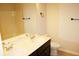 Bathroom featuring double sinks, dark cabinets, and a bathtub at 4020 Alligator Pt, Cumming, GA 30028