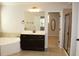Bathroom with double vanity, bathtub, shower and large mirror at 4020 Alligator Pt, Cumming, GA 30028