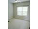 Cozy bedroom featuring a large window and neutral carpeting at 4020 Alligator Pt, Cumming, GA 30028