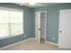 Bright bedroom with a ceiling fan, closet, neutral carpet, and a large window at 4020 Alligator Pt, Cumming, GA 30028