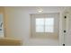 Bedroom with neutral carpet, window and a view to a hallway at 4020 Alligator Pt, Cumming, GA 30028