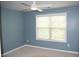 Bright bedroom with a ceiling fan, neutral carpet, and a large window at 4020 Alligator Pt, Cumming, GA 30028
