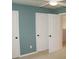 Bright bedroom with a ceiling fan, doors, and neutral carpet at 4020 Alligator Pt, Cumming, GA 30028