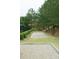 Community bocce ball court surrounded by lush landscaping and walking paths, perfect for friendly games and socializing at 4020 Alligator Pt, Cumming, GA 30028