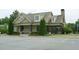 Community clubhouse featuring covered porch, manicured landscaping, and convenient parking at 4020 Alligator Pt, Cumming, GA 30028