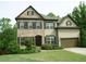 Charming two-story home with a brick facade and a well-manicured lawn at 4020 Alligator Pt, Cumming, GA 30028