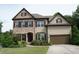 Charming two-story home featuring a brick and siding facade, well-manicured lawn, and a two-car garage at 4020 Alligator Pt, Cumming, GA 30028
