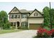 Charming two-story home boasts brick and siding exterior, well-manicured lawn, and a two-car garage at 4020 Alligator Pt, Cumming, GA 30028