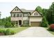 Beautiful two-story home featuring brick and siding, a well-kept lawn, and an attached two-car garage at 4020 Alligator Pt, Cumming, GA 30028