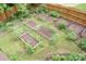 Aerial view of an organized backyard garden featuring raised beds, mulch, and mature greenery at 4020 Alligator Pt, Cumming, GA 30028
