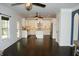 Open concept kitchen featuring white cabinets, an island, stainless steel appliances, and hardwood floors at 4020 Alligator Pt, Cumming, GA 30028
