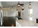 Open living area featuring a granite countertop island, fireplace, and an entrance to the screened porch at 4020 Alligator Pt, Cumming, GA 30028