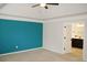 This main bedroom has a striking accent wall, plush carpet, and ensuite bath at 4020 Alligator Pt, Cumming, GA 30028