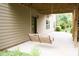 Relaxing patio with a charming swing, perfect for enjoying the outdoors at 4020 Alligator Pt, Cumming, GA 30028