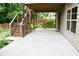 Spacious patio area with overhead deck and a charming swing, perfect for outdoor relaxing at 4020 Alligator Pt, Cumming, GA 30028
