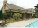 Relaxing poolside view with a covered patio and lush landscaping at 4020 Alligator Pt, Cumming, GA 30028