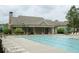 Community pool with ample lounge chairs and clubhouse in the background at 4020 Alligator Pt, Cumming, GA 30028