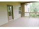 Comfortable screened-in porch with a view of the backyard through the trees at 4020 Alligator Pt, Cumming, GA 30028