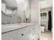 Bright bathroom featuring dual sinks, granite countertops, and modern fixtures at 4384 Herschel Rd, College Park, GA 30337