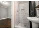 Modern bathroom features marble shower with river rock base and sleek fixtures at 4384 Herschel Rd, College Park, GA 30337