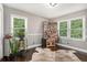 Bedroom showcasing hardwood floors, natural light, and neutral walls at 4384 Herschel Rd, College Park, GA 30337
