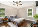 Bedroom boasts hardwood floors, neutral walls, large windows, ceiling fan and stylish decor at 4384 Herschel Rd, College Park, GA 30337