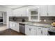 Bright kitchen with stainless steel appliances, granite countertops, and white cabinetry at 4384 Herschel Rd, College Park, GA 30337