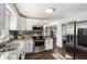 Well-lit kitchen with stainless steel appliances, granite countertops, modern cabinets, and stainless steel refrigerator at 4384 Herschel Rd, College Park, GA 30337