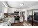 Modern kitchen featuring stainless steel appliances, granite countertops, and custom cabinets at 4384 Herschel Rd, College Park, GA 30337