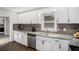 This is a well-lit kitchen with granite countertops and stainless steel appliances and white cabinets at 4384 Herschel Rd, College Park, GA 30337