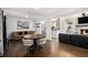 Open-concept living and dining area featuring hardwood floors and abundant natural light at 4384 Herschel Rd, College Park, GA 30337