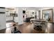 Open-concept living and dining area featuring hardwood floors and abundant natural light at 4384 Herschel Rd, College Park, GA 30337