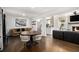 Inviting living room featuring hardwood floors, fireplace, and an adjacent dining area with stylish seating at 4384 Herschel Rd, College Park, GA 30337