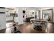 Open-concept living space showing hardwood floors, kitchen access, fireplace and stylish decor at 4384 Herschel Rd, College Park, GA 30337