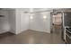 Open basement area with tile floors, white walls, and modern sconces ready for living or conversion at 591 E Morningside Ne Dr, Atlanta, GA 30324