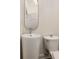 Compact bathroom with a sleek pedestal sink, toilet, and a modern elongated mirror, maximizing space at 591 E Morningside Ne Dr, Atlanta, GA 30324