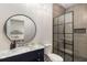 Elegant bathroom showcasing a glass shower, a modern vanity with a marble top, and a round mirror at 591 E Morningside Ne Dr, Atlanta, GA 30324