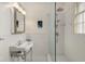 Clean bathroom featuring a glass shower, classic subway tile, and a pedestal sink with vintage-style fixtures at 591 E Morningside Ne Dr, Atlanta, GA 30324