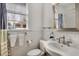 Bright bathroom with a classic white tile, pedestal sink and a mirror reflecting natural light from the window at 591 E Morningside Ne Dr, Atlanta, GA 30324