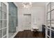 Modern bathroom with a glass-enclosed shower, stylish chandelier, and a navy blue vanity with marble countertop at 591 E Morningside Ne Dr, Atlanta, GA 30324