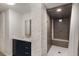 Basement bathroom showcases modern vanity, a walk-in tiled shower, and brick accent wall at 591 E Morningside Ne Dr, Atlanta, GA 30324