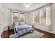 Cozy bedroom filled with natural light, showcasing hardwood floors, neutral walls, and comfortable furnishings at 591 E Morningside Ne Dr, Atlanta, GA 30324