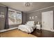 Serene bedroom featuring a neutral color palette, dark hardwood floors, and a large window for ample natural light at 591 E Morningside Ne Dr, Atlanta, GA 30324