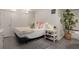 Basement bedroom featuring tile floors, white walls, a neutral bed, and minimalist decor at 591 E Morningside Ne Dr, Atlanta, GA 30324