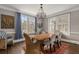 Elegant dining room with a large wooden table, stylish chairs, and natural light from large windows at 591 E Morningside Ne Dr, Atlanta, GA 30324