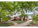 Beautiful two-story home with brick and siding, complemented by lush greenery and a driveway at 591 E Morningside Ne Dr, Atlanta, GA 30324
